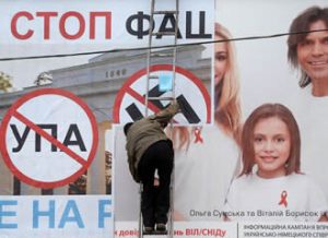 Anti-Kyiv billboard... being plastered over an AIDS awareness advert. Image: Filippo Monteforte / AFP / Lehtikuva